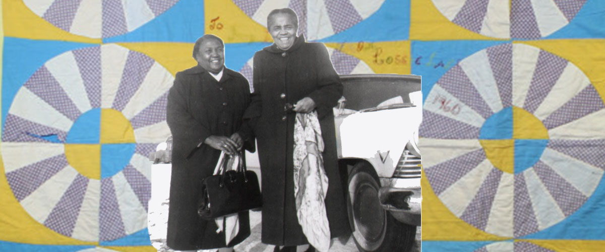 A black and white photo of Lossie Lane and Ivy Beaver superimposed on top of a Wagon Wheel quilt made by Lossie Lane. The quilt has black and grey wheels over yellow and blue boxes.