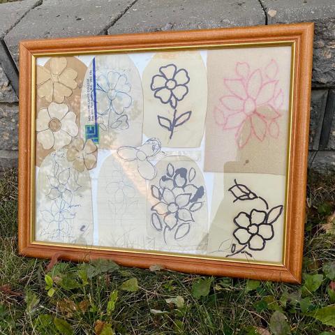 An orange frame holds multiple images of beaded flowers in black, white and pink. 