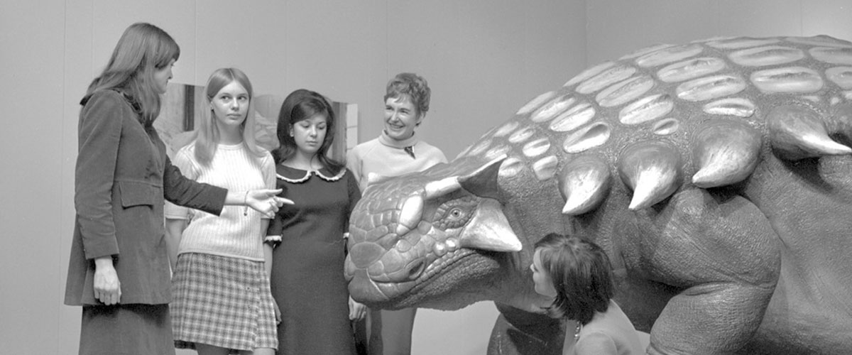 old photograph of visitors in the dinosaur hall
