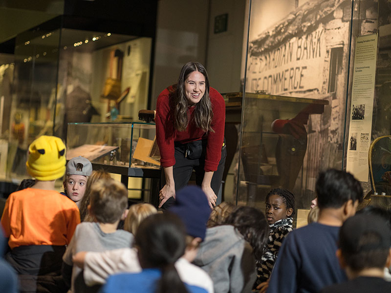 A Learning staff engages children in the gallery.