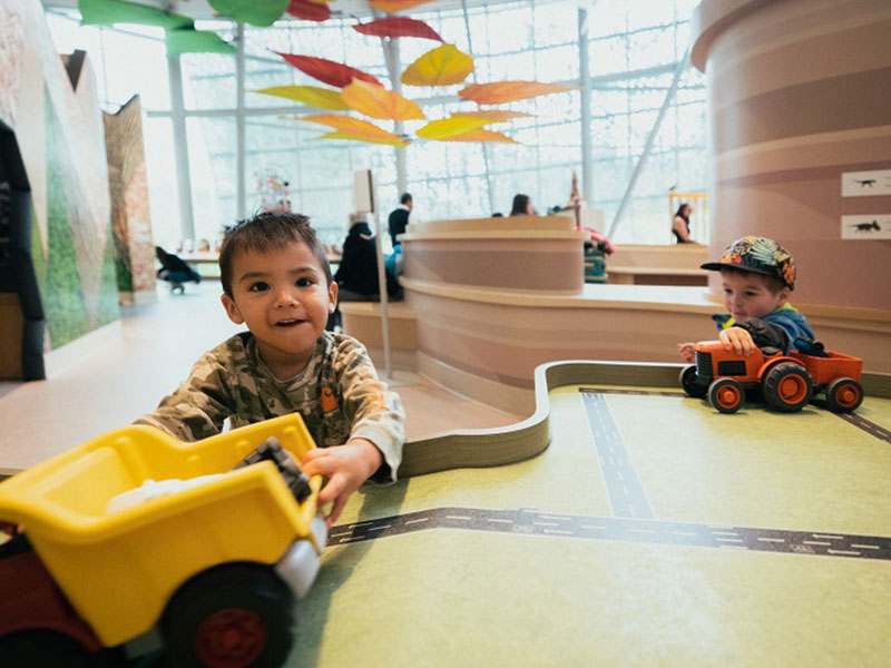 A child playing with a toy truck in the Children's Gallery