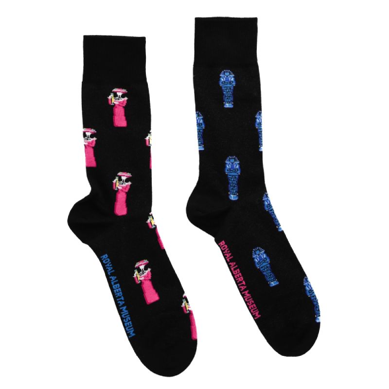A pair of black socks with pink and blue art from the exhibition.'