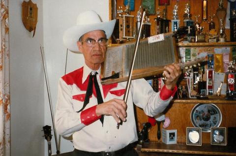 Electric fiddles made from a washboard and a tea kettle