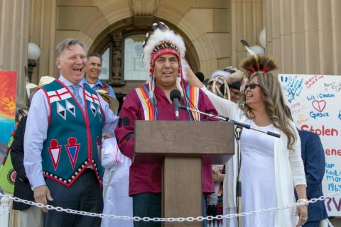 Former Minister of Indigenous Relations, Richard Feehan, President of SSISA, Adam North Peigan and Vice President and Co-Founder of SSISA Sharon Gladue addressing the audience after the apology to Sixties Scoop survivors, May 28, 2018. Photo courtesy of Brad Crowfoot.