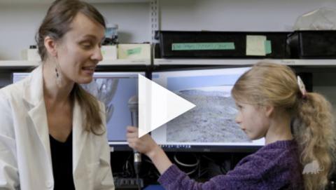 RAM Curator Diana T and her daughter Sia sit in a lab talking about science