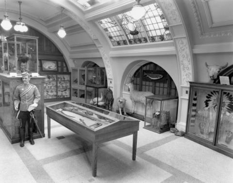 The Carillon Room, where RAM began. A number of display cases and table in a white room with a domed roof.