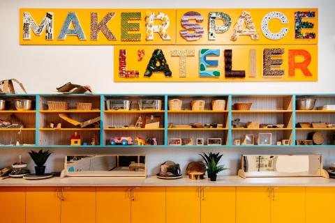 Shelves and counter in the Makerspace at Royal Alberta Museum. The shelves are filled with many colourful toys and craft supplies.