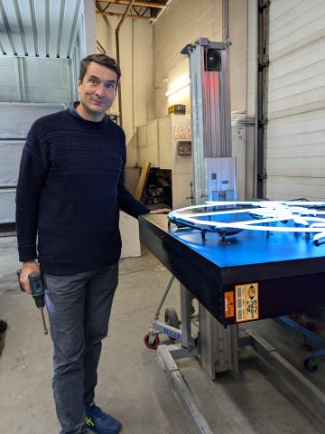 Mark Scheuer, owner of City Neon, with the lit Flashback sign.