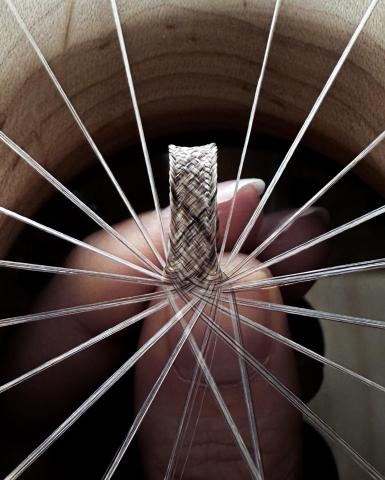 Close up photo of spools of hair being braided.