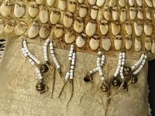 A photo of a hide skin dress, adorned with beads and elk ivory pendants