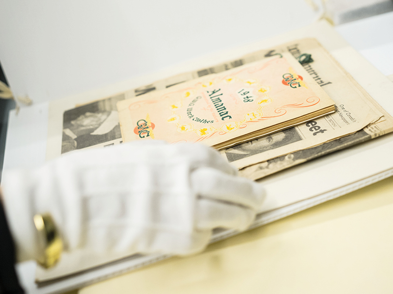 a pair of hands with white gloves takes care of an object